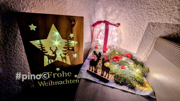 Weihnachtliche Dekoration mit Stern, Rehen und festlichem Lichterkranz.